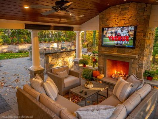 Outdoor porch with TV, fireplace and heaters by Land Design Associates